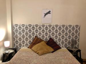 a bedroom with a bed with a black and white wall at Templar Secrets House in Tomar