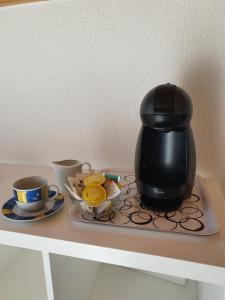 a coffee pot sitting on a tray on a table at Haus Artemis in Saas-Grund