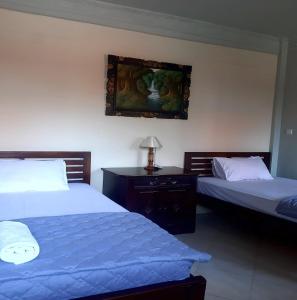 Postel nebo postele na pokoji v ubytování The Reinhold Guesthouse Bali
