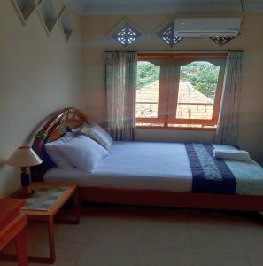 Postel nebo postele na pokoji v ubytování The Reinhold Guesthouse Bali
