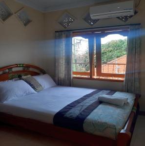 Postel nebo postele na pokoji v ubytování The Reinhold Guesthouse Bali