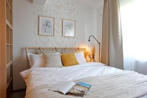 a bedroom with a bed with a book on it at New & cozy studio in Ghencea + Netflix in Bucharest