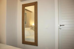 a mirror on a wall next to a bedroom at 19 Oda Bozcaada in Çanakkale +68 photos