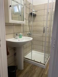 a bathroom with a sink and a shower at Villetta Martino Guest House in Torre Chianca