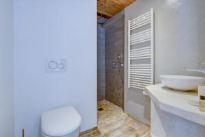a bathroom with a white toilet and a sink at Edelweiss Cosy in Morzine