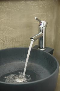 a sink with water coming out of a faucet at Lakki Village in Aegiali