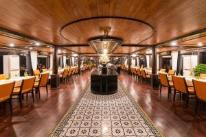a dining car of a train with tables and chairs at Victory Star Cruise in Ha Long