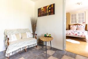 a bedroom with a bed and a chair and a table at Dorlanne in Saint-Palais +4 photos