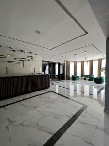 a large lobby with a large marble floor at Эдем in Shymkent