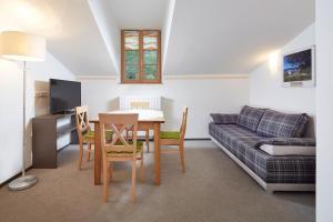 uma sala de estar com uma mesa e um sofá em Gasthof Salzstadl em Reutte