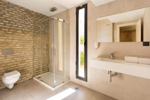a bathroom with a shower and a toilet and a sink at Black Swan the Penthouse in Seville +31 photos