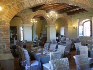 a dining room with tables and chairs in a building at Tenuta Vento di Mare in Lido Di Fondi