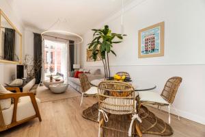 a living room with a table and chairs at Madrid 1915 Private Suites in Madrid