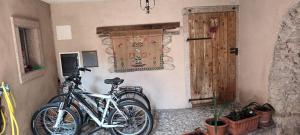 two bikes are parked in a room with a door at Casa SAN FELICE in Mori
