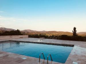 a swimming pool with a view of the mountains at La Lazarenco Piscine 1 in Le Plan-de-la-Tour