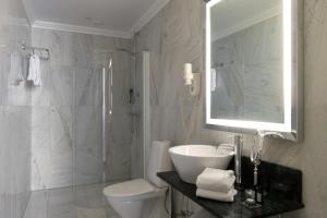 a bathroom with a sink and a toilet and a shower at Elite Plaza Hotel Malmö in Malmö +44 photos