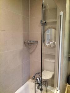 a bathroom with a shower, toilet and sink at The Dial House in Bourton on the Water