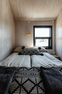 a bedroom with a bed in a small room at Ocean Break Cabins in Sandgerði