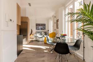 a kitchen and living room with a table and chairs at Madrid 1915 Private Suites in Madrid