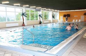 a large swimming pool with people in the water at Ferienwohnung Wanderkönige in Braunlage