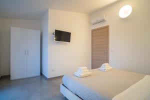 Postel nebo postele na pokoji v ubytování Il Crepuscolo Marzamemi