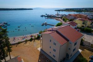 a view of a beach with people in the water at Apartments Villa Alba in Banjol