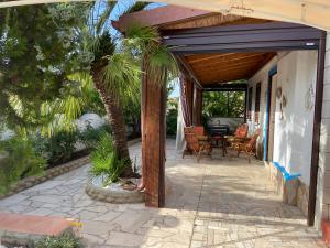 un patio con una mesa y una palmera en Villa Gino, en Santa Lucia