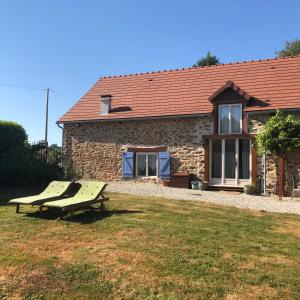 a stone house with a picnic bench in front of it at Les Landes in Saint-Pardoux-Corbier