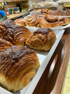 a bunch of croissants and other pastries on a table at OA Surf Club in Bude