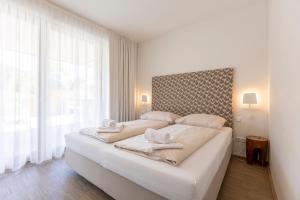 Łóżko lub łóżka w pokoju w obiekcie Alpenrock Schladming by ALPS RESORTS
