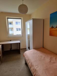 a bedroom with a bed and a window at Onkel Tom Alpen & Sahara in Paderborn