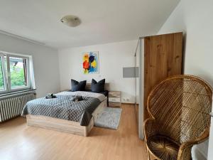 a bedroom with a bed and a chair in it at Sarah's Zugspitz Inn in Garmisch-Partenkirchen