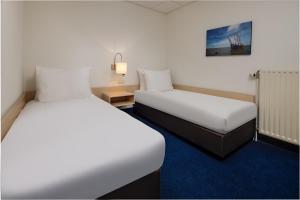 Voodi või voodid majutusasutuse WestCord Hotel Schylge toas