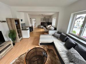a living room with a couch and a table at Sarah's Zugspitz Inn in Garmisch-Partenkirchen