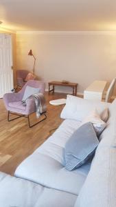a living room with two beds and a couch at Lovely 2 bedroom flat in the heart of water Wimbledon in London