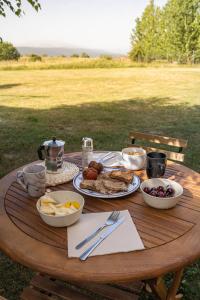 a wooden table with plates of food on it at Val de Llous I 40 in Sainte-Léocadie