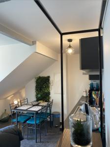 a dining room with a table and chairs at Le Grenier Saint-Pierre in Verdun