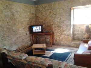 a living room with a couch and a tv at Historical 4 - Bedroom Villa in Alcobaca in Alcobaça
