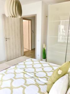 a bedroom with a large bed with a patterned floor at Elizabeth Garden Premium Apartment in Kecskemét