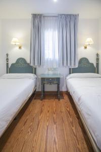 Säng eller sängar i ett rum på Apartamentos Soho Boutique Vistahermosa