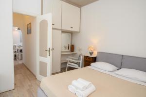 a bedroom with a bed with two towels on it at Lakki Village in Aegiali