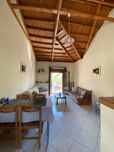 a living room with a table and a couch at Roxani Studios-Apartments in Petra