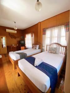 Ένα ή περισσότερα κρεβάτια σε δωμάτιο στο Sila Resort Sukhothai