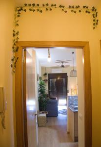 a hallway with a living room and a door with leaves on the wall at Grace, apartamento con terraza y vistas in Talarn