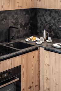 a kitchen with a sink and a counter top at Oberfallerhof Apartment Ummi in Barbiano +28 photos