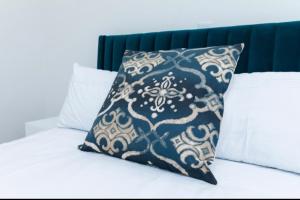 a black and white pillow sitting on top of a bed at Luxurious 1 Bedroom Apartment Available in Accra