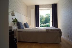 Säng eller sängar i ett rum på Bäckaskog Slott