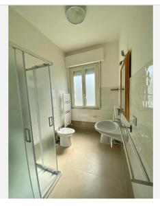 uma casa de banho com um WC, um lavatório e um chuveiro em Appartamento in centro, a 150 m dal mare em Pineto