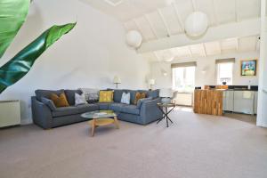 a living room with a couch and a table at Peaceful, rural cottage on the outskirts of Padstow in Padstow