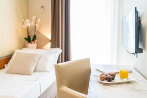Posteľ alebo postele v izbe v ubytovaní Hotel Royal